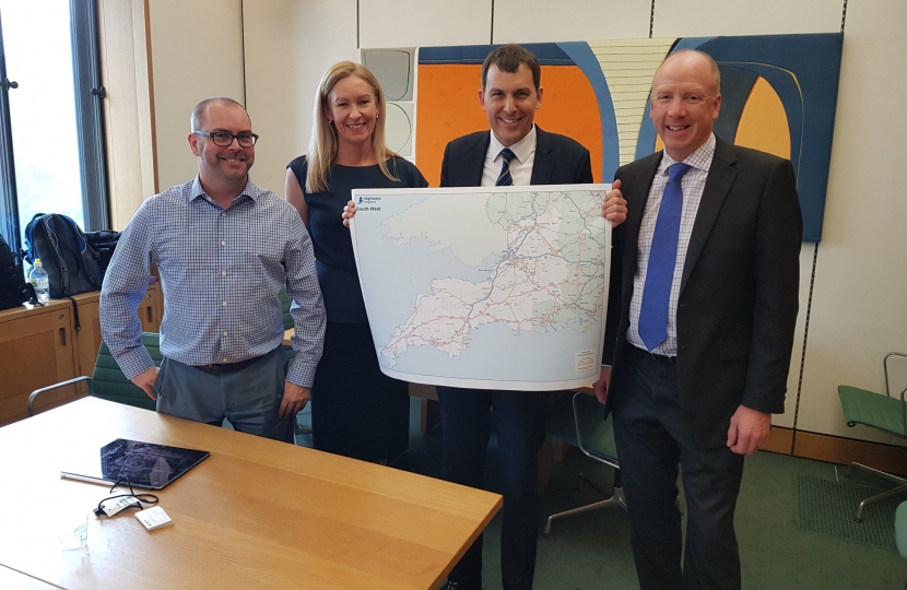 John holding map with Highways England employees