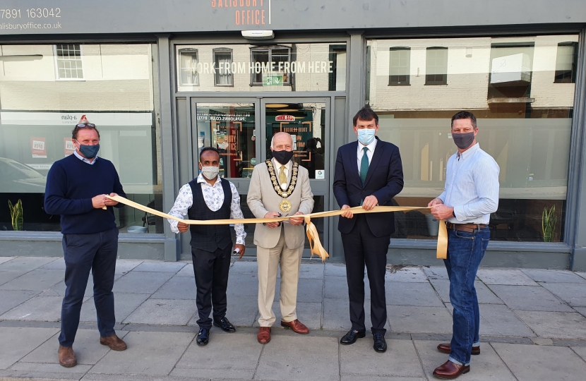 John holding the opening ribbon, next to Salisbury Mayor on his left, Cllr Hoque on his right and Salisbury Office team.  