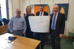 John holding map with Highways England employees