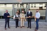 John holding the opening ribbon, next to Salisbury Mayor on his left, Cllr Hoque on his right and Salisbury Office team.  