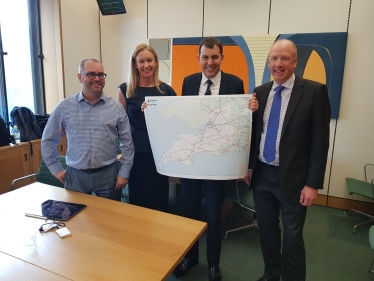 John holding map with Highways England employees