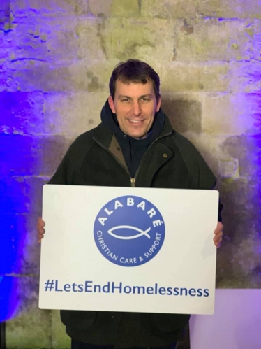 John holding an Alabaré⁩ sign